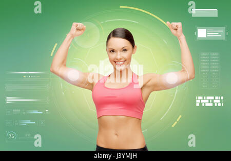 Happy sporty woman showing biceps Banque D'Images
