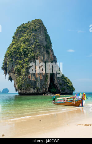 Vue panoramique sur plage et bateau longtail contre la montagne érodée par la mer Banque D'Images