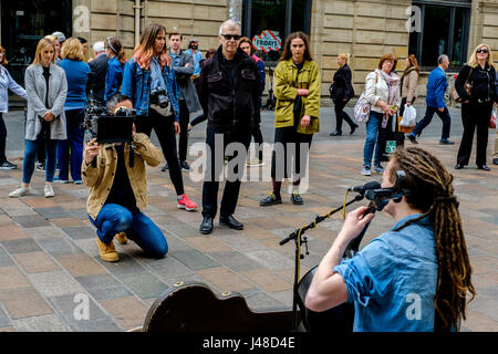 GLASGOW, Ecosse 10 Mai 2017 : Paisley violoncelliste/chanteur/compositeur CALUM INGRAM jouant du violoncelle dans Buchanan Street Glasgow tout en étant filmé pour Banque D'Images