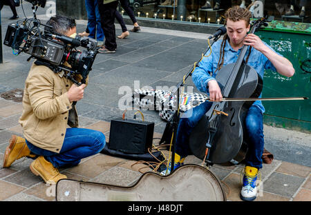 GLASGOW, Ecosse 10 Mai 2017 : Le violoncelliste/singer/songwriter, Paisley né INGRAM CALUM Rue tout en étant filmé pour un documentaire Dans Buchanan Street, Banque D'Images