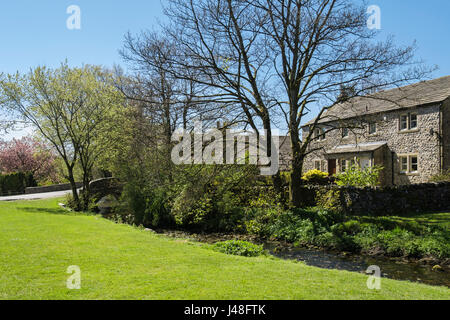 Maison en pierres avec vue sur village green et Malham Beck à Malham, Malhamdale, Yorkshire Dales National Park, North Yorkshire, Angleterre, Royaume-Uni, Angleterre Banque D'Images