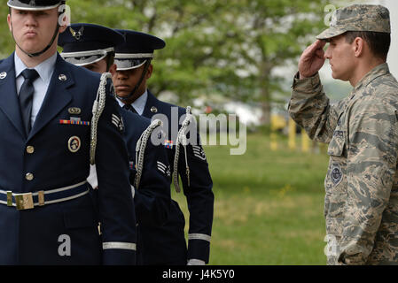 Le commandant du 32e escadron de renseignement salue les gardes d'honneur de la base de la 70e escadre de renseignement, de surveillance et de reconnaissance portant le drapeau américain lors de la cérémonie annuelle de retraite le 20 avril. La cérémonie honore le patrimoine de la 32e EI et maintient les traditions militaires et les normes cérémonielles. Banque D'Images