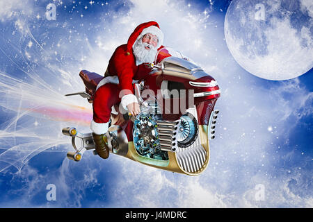 Santa flying in sky sur moto futuriste Banque D'Images