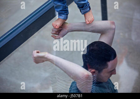 (170515) -- Venise, 15 mai 2017 (Xinhua) -- Un artiste exécute au pavillon de l'Allemagne lors de la 57e Biennale d'Art à Venise, Italie, le 13 mai 2017. La chorégraphe allemande Anne Imhof a reçu le Lion d'or de la meilleure participation nationale à la 57e Biennale d'Art à Venise. Pour sa pièce intitulée 'Faust' après l'allemand classique histoire d'un homme qui vend son âme au diable en échange de connaissances et de pouvoir illimité, Imhof a rempli le blanc, Pavillon rectangulaire de l'Allemagne avec l'intersection des murs de verre et d'étages, et ensuite placé un groupe d'artistes interprètes ou exécutants dans le sous-sol. Observer les visiteurs Banque D'Images