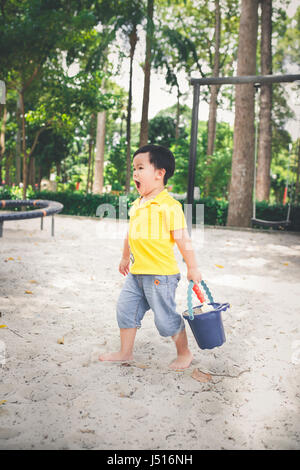 Adorable petit garçon asiatique dans un parc sur une belle journée en plein air Banque D'Images