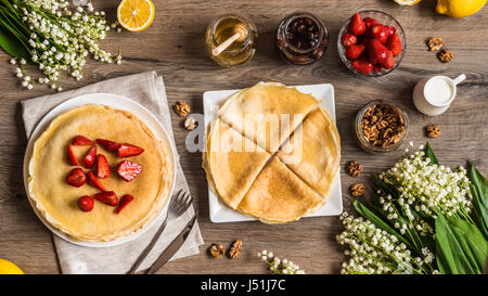 Vue de dessus de délicieuses crêpes sur table en bois avec des fruits Banque D'Images