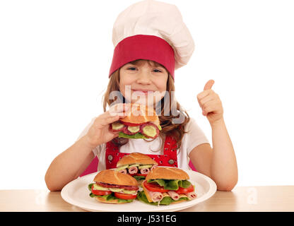 Happy little girl cook avec sandwich et thumb up Banque D'Images