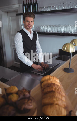 Portrait of waiter holding comptoir dans un restaurant Banque D'Images