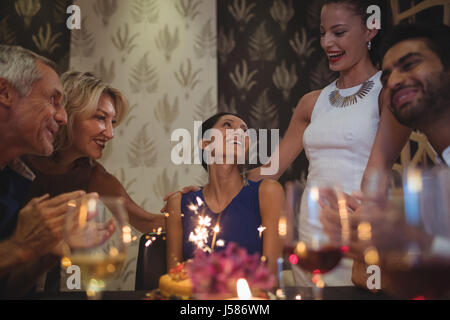 Group of friends celebrating birthday in restaurant Banque D'Images