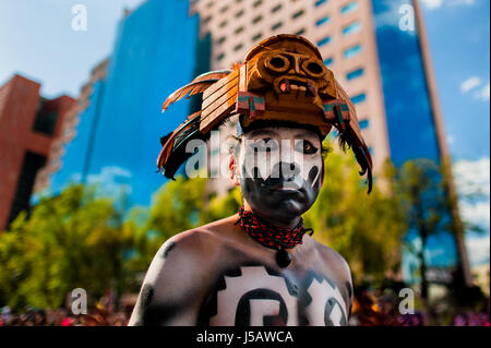 Un homme, vêtu d'un masque de plumes colorés inspirés par les Aztèques, prend part à la Journée de la mort parade dans la ville de Mexico, Mexique. Banque D'Images