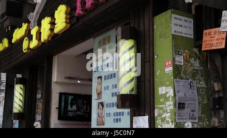 Salon de coiffure et institut de beauté avec cheveux solon avec enseigne de barbier à rayures à Sham Shui Po Kowloon Hong Kong Banque D'Images