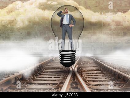 Digital composite of Businessman in ampoule au-dessus les voies Banque D'Images