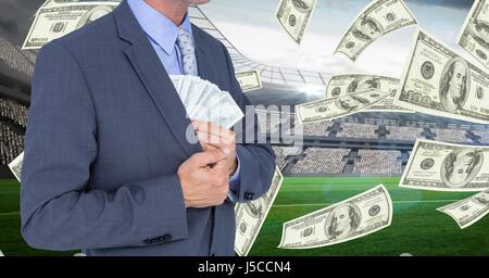 Digital composite de Midsection of young de l'argent dans blazer au stade de football représentant la corruption Banque D'Images