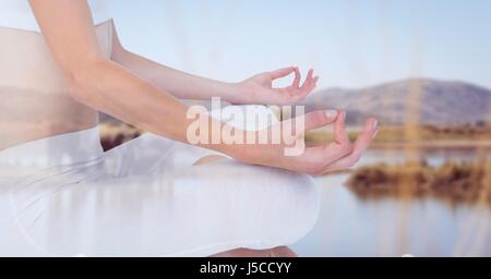 Digital composite de Midsection of woman sitting by lake Banque D'Images