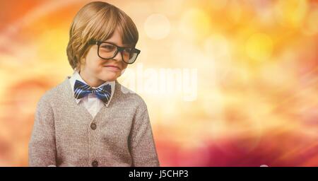 Digital composite of Smiling boy wearing costume et lunettes sur bokeh Banque D'Images