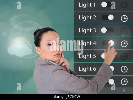 Digital composite of Woman touching Home Automation System Interface Application d'éclairage Banque D'Images