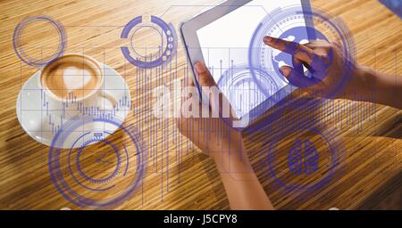 Digital composite of High angle view of hands using tablet PC par tasse sur la table notamment sur l'emplacement Banque D'Images