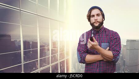 Digital composite of Portrait of businessman holding pipe contre les bâtiments Banque D'Images