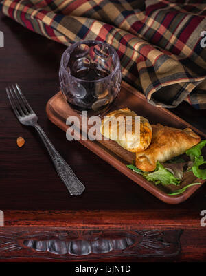 Un style à partir de la Patagonie : Deux empanadas et un verre de vin dans une retraite chic dans le sud du monde. Banque D'Images