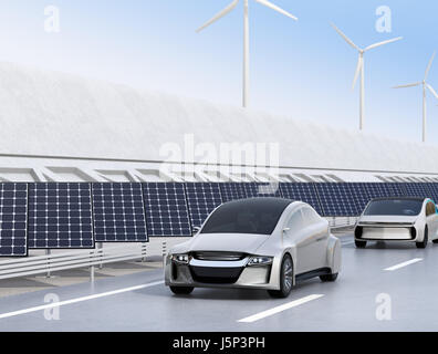 Voiture électrique la conduite sur la voie de charge sans fil de l'autoroute. Panneau solaire et éolienne sur la route. Le rendu 3D image. Banque D'Images