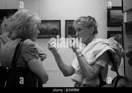Exposition photographique. Les visiteurs et les participants discuter activement les photos présentées. Banque D'Images