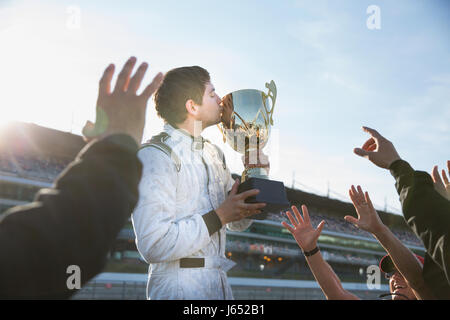 Formula One Racing team cheering autour du kissing trophy, célébrant la victoire Banque D'Images