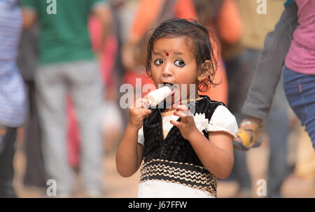 Katmandou, Népal - Apr 15, 2017 : Petite fille dévorant une une glace lolly. Banque D'Images