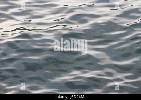 La surface d'un océan froid et gris avec des ondulations et des vagues qui sont sombres et contrastées entre dans une image complète image de fond de la nature.. Banque D'Images