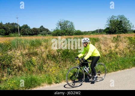 Une femme touring cyclist riding son vélo en titane dans la campagne de la province de Gérone, Espagne. Banque D'Images