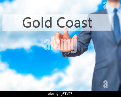 Gold Coast - main homme d'appui bouton sur l'interface de l'écran tactile. Le commerce, la technologie, internet concept. Stock Photo Banque D'Images