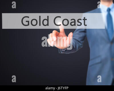 Gold Coast - main homme d'appui bouton sur l'interface de l'écran tactile. Le commerce, la technologie, internet concept. Stock Photo Banque D'Images