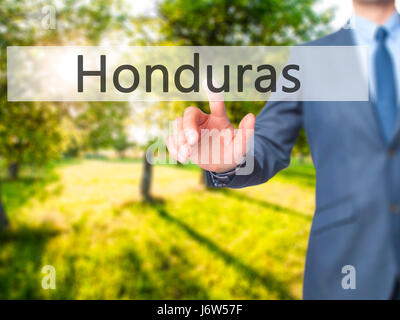 Honduras - Businessman hand appui bouton sur l'interface de l'écran tactile. Le commerce, la technologie, internet concept. Stock Photo Banque D'Images