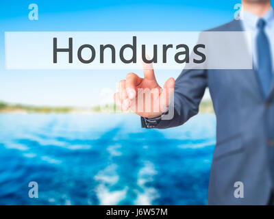 Honduras - Businessman hand appui bouton sur l'interface de l'écran tactile. Le commerce, la technologie, internet concept. Stock Photo Banque D'Images