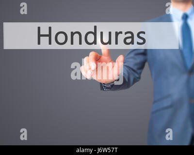 Honduras - Businessman hand appui bouton sur l'interface de l'écran tactile. Le commerce, la technologie, internet concept. Stock Photo Banque D'Images