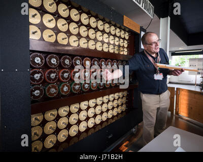 Un docent explique un groupe de reconstitution de la machine de Turing ou bombe au domicile de l'WWll décrypteurs à Bletchley Park en Angleterre. Banque D'Images