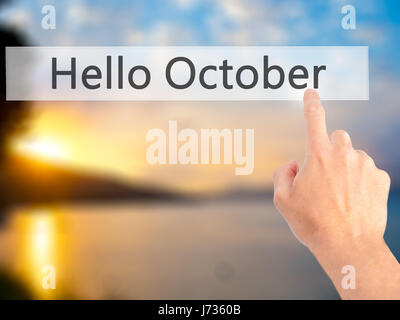 Bonjour Octobre - part en appuyant sur un bouton sur l'arrière-plan flou concept . Le commerce, la technologie, internet concept. Stock Photo Banque D'Images