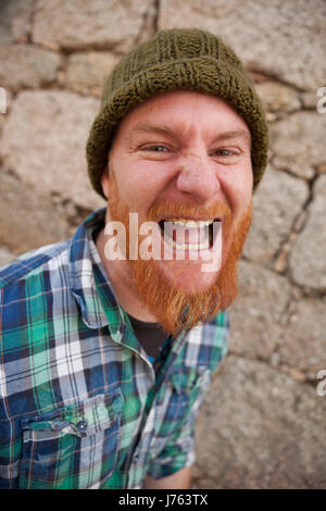 Portrait of a red haired hipster guy mettant face stupide Banque D'Images