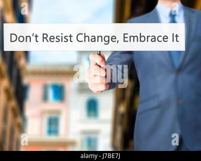 Ne pas résister au changement, l'embrasser ! - Businessman hand holding sign. Le commerce, la technologie, internet concept. Stock Photo Banque D'Images