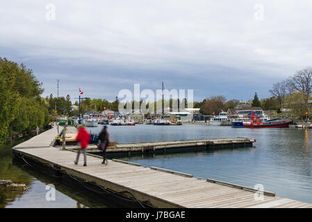 Peu à remous promenade du port avec des gens qui marchent le long de celui-ci au crépuscule, Tobermory, Ontario, Canada Banque D'Images