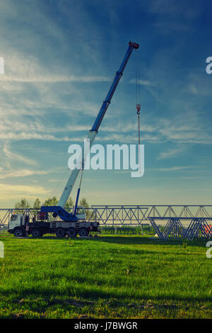 Location de grue à flèche télescopique monté à l'extérieur, sur le site de construction. Banque D'Images