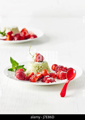 Matcha panna cotta aux fraises et noix de coco en flocons Banque D'Images