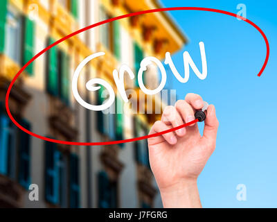 Man main écrit grandir avec marqueur noir sur l'écran visuel. Isolé sur fond. Le commerce, la technologie, internet concept. Stock Photo Banque D'Images