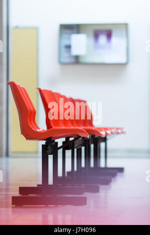 Rangée de chaises en plastique rouge à l'hôpital salle d'attente Banque D'Images