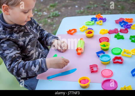 Cute little boy Playing with Plasticine Banque D'Images