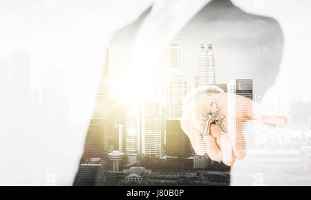 Close up of businessman holding keys Banque D'Images