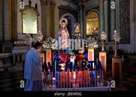 Un prêtre catholique, debout à un autel décoré à l'intérieur de San Agustin Church ou Iglesia de la Inmaculada Concepcion de Maria de San Agustin situé situé à l'intérieur de la ville fortifiée historique de Manille appelée Intramuros dans la ville de Manille, capitale des Philippines Banque D'Images