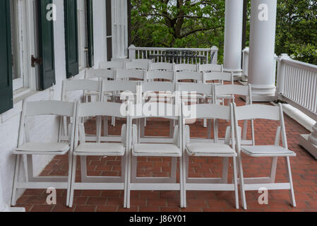 Des rangées de chaises pliantes blanches sur Patio de brique vous attendent Banque D'Images