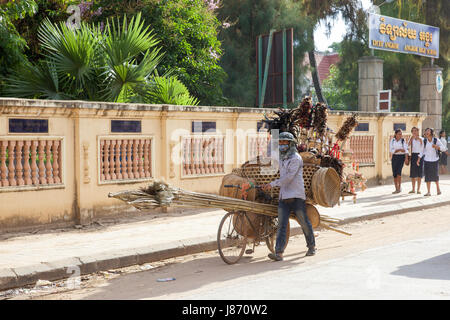 SIEM REAP, Cambodge - 3 juillet : vendeur cambodgien pousse son vélo chargé avec des paniers tissés et des balais le 3 juillet 2014 au Siam Reap, Cambodge. Banque D'Images