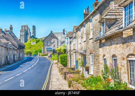 Route à travers le château de Corfe village avec vue sur le château de Corfe Castle, Dorset UK en mai Banque D'Images