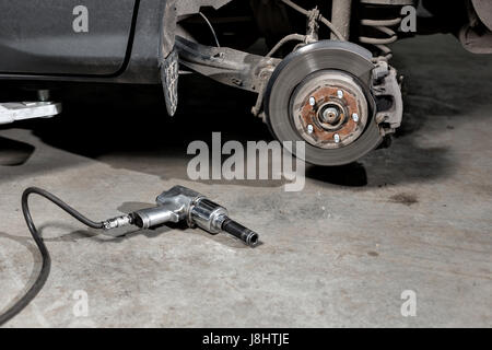 Frein à disque libre du véhicule pour réparation. tourné la roue, l'outil pour desserrer les écrous des vis internes. Banque D'Images